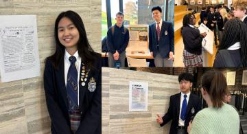 Students standing with posters detailing research